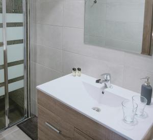 a bathroom with a white sink and a shower at El Cielo Azul in Alora +110 photos
