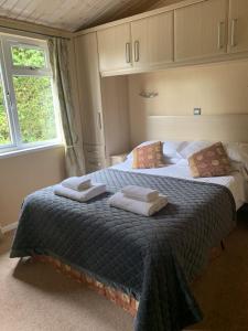 a bedroom with two beds with towels on them at Park Lodge in Penrith