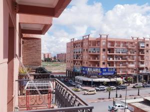 a balcony with a view of a street and buildings at Sabor Apartment Anas Majorelle in Marrakech
