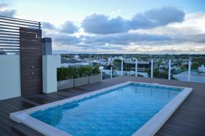 a swimming pool on the roof of a building at Inizio Hotel in San Francisco