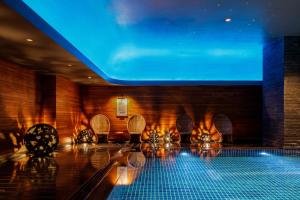 a bowling alley with chairs and a blue light at Lotte Hotel Moscow - The Leading Hotels of the World in Moscow