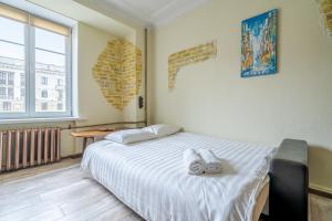 a bedroom with a bed with two towels on it at Apartment on Kirova in Minsk