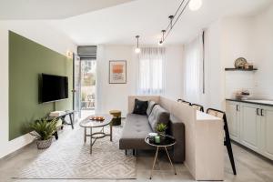 a living room with a couch and a table at Mr. Agrippa - By TLV2GO in Jerusalem