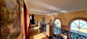 a hallway with a balcony with a large window at Sandmartins Private Secure Villa in Simondium