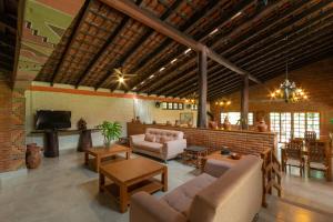 a large living room with couches and a tv at Pousada Olho D'Água in Bonito