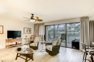 a living room filled with furniture and a flat screen tv at Kauai Beach Villas D10 in Lihue