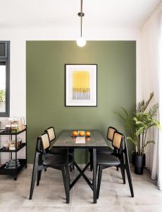 a dining room with a black table and chairs at Mr. Agrippa - By TLV2GO in Jerusalem