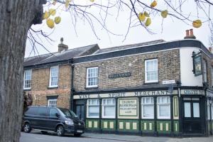 a van parked in front of a brick building at The Countryman Hideaway - Funky Loft Room in Gillingham