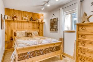 a bedroom with a bed and a wooden wall at Lazy Bear Retreat in Mevers