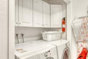 a white laundry room with a washer and dryer at Lazy Bear Retreat in Mevers