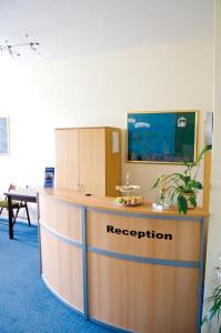 an reception desk in an office with a sign on it at City Inn in Berlin