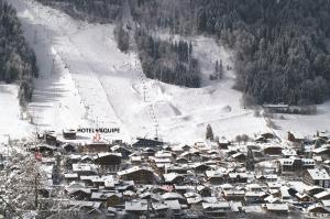 a small town in the snow with a ski slope at Hotel L'Equipe in Morzine