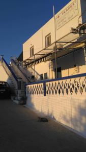 a white building with stairs on the side of it at Hotel Glaros Lipsi in Leipsoi