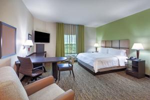 a hotel room with a bed and a desk at Candlewood Suites - Houston - Pasadena, an IHG Hotel in Pasadena