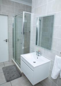 a bathroom with a sink and a glass shower at The Blyde Riverwalk Estate, Crystal Lagoon, Pretoria east in Pretoria