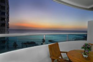 a balcony with a table and a view of the ocean at Horizon Apartment in Cartagena de Indias