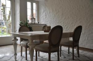 a dining room with a white table and chairs at Maison de Charme "Le Moulin d'Hagenthal" - Chambre Romantique in Hagenthal-le-Bas