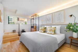 a bedroom with a large white bed with pillows at Villa Almada - Amazing City Centre Villa with Private Pool in Porto +17 photos