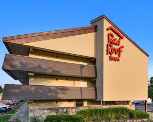 a building with a red sign on the side of it at Red Roof Inn Lexington South in Lexington