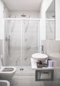 a bathroom with a shower and a sink and a toilet at Correnti Boutique Hotel in Sanremo