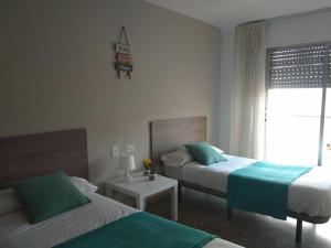 Postel nebo postele na pokoji v ubytování Hostal Garamar