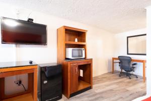 a room with a desk with a tv and a chair at Hotel O Atlanta Airport Jonesboro/Morrow I-75 in Jonesboro