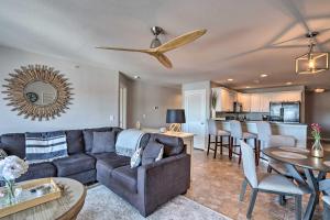 a living room with a couch and a table at Lakefront Missouri Condo with Pool Access and Balcony in Camdenton