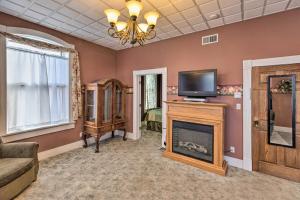 a living room with a fireplace and a television at Pet-Friendly Apt Walk to Missouri River! in Yankton