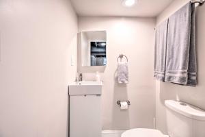 a white bathroom with a sink and a toilet at Home with Office and Yard 25 Mi to Downtown Chicago! in Glen Ellyn +30 photos