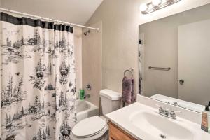 a bathroom with a sink and a toilet and a shower curtain at Near Hiking and Fishing Munds Park Cabin with Deck in Munds Park +17 photos