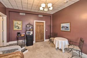 a living room with purple walls and a table at Pet-Friendly Apt 2 Blocks to Riverside Park! in Yankton