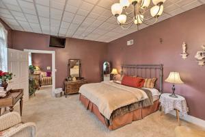 a bedroom with a bed and a chandelier at Pet-Friendly Apt 2 Blocks to Riverside Park! in Yankton
