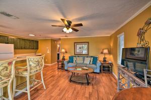 a living room with a couch and a tv at Gulfview Lido Key Gem - Walk to Beach and Shops in Sarasota
