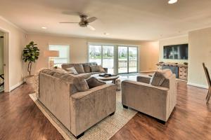 a living room with two couches and a table at Waterfront Home with Private Beach on Lake Norman! in Mooresville