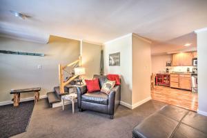 a living room with a couch and a chair at Cozy Condo by Mirror Lake, 1 Block to Downtown! in Lake Placid