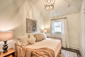 a bedroom with a bed with a chandelier and a window at The Ultimate Luxury Retreat on Lake Burton! in Clayton