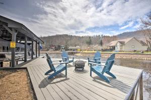 a dock with three blue chairs and a grill at The Ultimate Luxury Retreat on Lake Burton! in Clayton