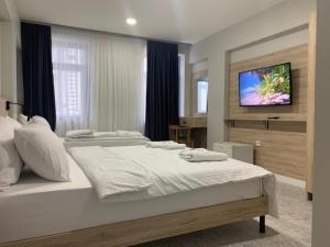 a bedroom with a large bed with a flat screen tv at Taksim Galatist Hotel in Istanbul