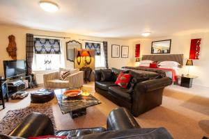 a living room with a couch and a bed at The Tankerville Arms in Eglingham