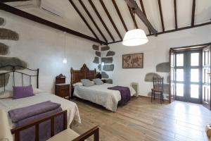 ファタガにあるVv La Casa Nueva Jacuzzi 6p, Wifi ,bbq, acのベッドルーム1室(ベッド2台付)
