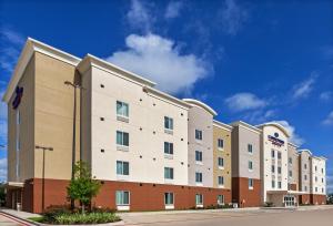a hotel building with a blue sky in the background at Candlewood Suites - Houston - Pasadena, an IHG Hotel in Pasadena