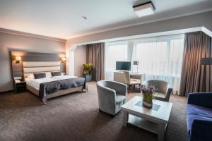 a hotel room with a bed and a living room at Bellevue Park Hotel Riga with FREE Parking in Rīga