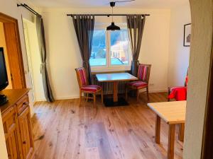 a dining room with a table and chairs and a window at REIT IM WINKL - ValleyViewInn in Reit im Winkl