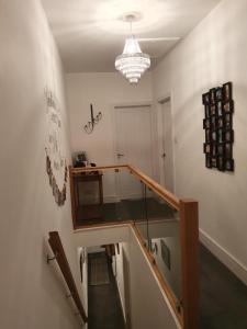 a staircase in a room with a chandelier at Cosy Double Room in Harrogate