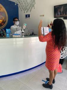 a woman standing in front of a barber shop at Quinta Santa Anita in Playa del Carmen