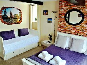 a bedroom with two beds and a brick wall at The Dove Inn in Micheldever