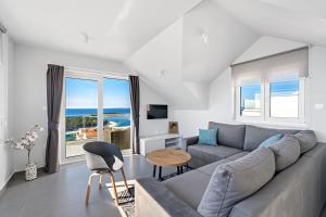 a living room with a couch and a table at Aquarelle Apartments Primošten apt no 1 and 3 in Primošten