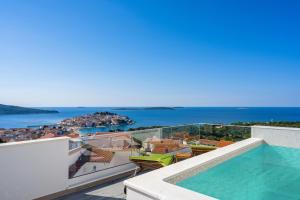 a view of the ocean from the balcony of a house at Aquarelle Apartments Primošten apt no 1 and 3 in Primošten