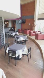 a group of tables and chairs in a room at Hotel Tlahuac in Mexico City