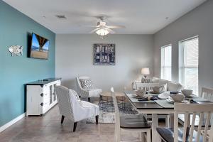 a dining room and living room with a table and chairs at A Piers to Be Tan in Port Aransas